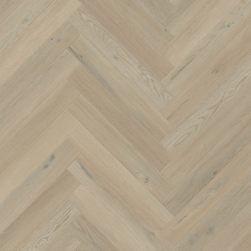 Light beige wood flooring planks arranged in a herringbone pattern, showing natural wood grain and subtle knots.